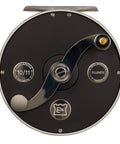 Cascapedia Fly Reel For Freshwater Trout And Two Handed Spey, Classic Clicker Ratchet, S Shaped Handle, Four Size Range, Sick Build From England For Smooth Line Control visible with black and silver finish.