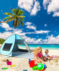 UPF 50+ Pop Up Beach Tent Auto Sun Shelter for 2 to 3 People on sandy beach with child and parent playing nearby