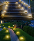 Solar Ground Lights Waterproof IP68 12 Pack Dual Purpose Outdoor Lights illuminating stairs and garden path at night