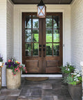 Double wooden door with Matte Black Entry Door Lock Set With Deadbolt And Straight Handle, Easy Install, surrounded by flowers.