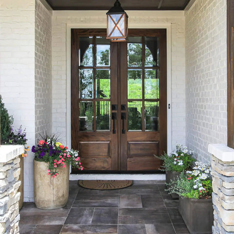 Double wooden door with Matte Black Entry Door Lock Set With Deadbolt And Straight Handle, Easy Install, surrounded by flowers.