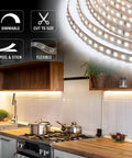 RibbonFlex Pro 12V White LED Strip Lights illuminating a modern kitchen under-cabinet area, showing flexible, cut-to-size tape feature.