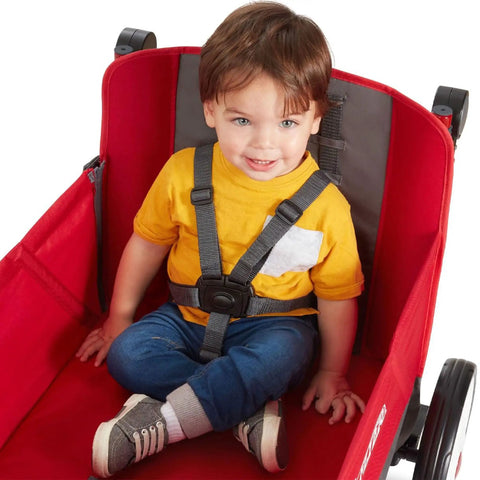 Child seated in Convertible Wagon Stroller for Kids 1 Plus Beach Cart With Wheels All In One Red Wagon Kid Friendly Travel and Play 5 Point Harness