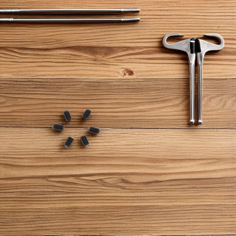 Hardcore Heavy Duty Ball Plunger Screws 50 Piece Stainless Steel M4x6 Quick Release Grub Bolts on wooden surface with tools.