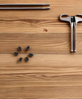 50 Piece M4x6 Stainless Steel Hex Ball Plunger Set Screws Tough As Nails Heavy Duty Fasteners on wooden surface.