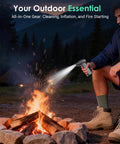 Person using Cordless Air Duster With 110000 RPM Brushless Motor to stoke campfire, showcasing versatility in outdoor use.