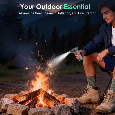 Person using Cordless Air Duster With 110000 RPM Brushless Motor to stoke campfire, showcasing versatility in outdoor use.