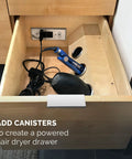 Discreet Drawer Mounted Power Station Featuring Brushed Stainless Steel GlidePanel with hair dryer and styling tools in a drawer.