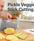 Front view of crinkle-cut French fry slicer with wooden handle and stainless blade, held over sliced potatoes.