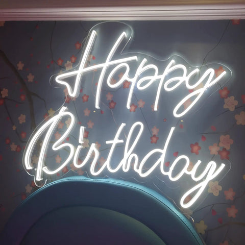 Happy Birthday Neon Sign LED Light, Large Silicone Neon, 16.9 X 6.7 Inches, glowing on floral backdrop