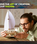 Ocean Beauty Yacht 3D Wooden Puzzle For Adults A Totally Relaxing DIY Mechanical Model Kit With Paper Sails A Brain Teaser Building Set For Home Office Decor And Shelf Display, man holding wooden sailboat model