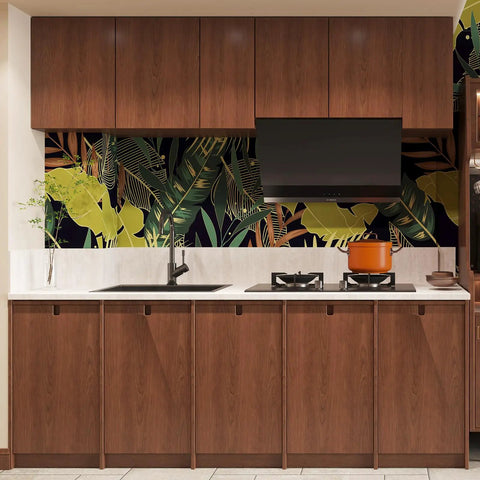 Modern kitchen with wood grain cabinets and tropical leaf wallpaper backsplash.