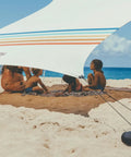 Family under Grande Portable Beach Tent Sun Shelter With 81 Sq Ft Shade 7 Ft Tall 9 By 9 Foot Canopy on beach