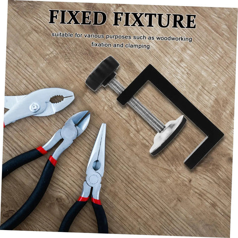 Fixed fixture clamp next to pliers on a wooden surface