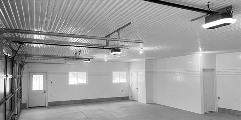 Interior view of a garage with white Trusscore Wall & Ceiling Board, showing trim and ceiling details for project planning.