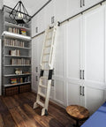 Rustic Black Sliding Library Ladder Hardware Kit With Track System And Brake Wheels No Ladder Included installed on white cabinet.