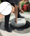 Man using Heavy Duty Manhole Cover Hook With T Shaped Handle 15 Inch Pull Tool for lifting a sewer cover