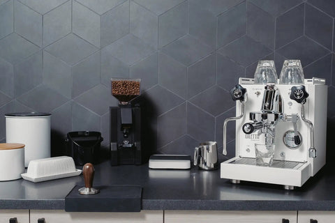 Next Level Home Bar Essentials Italian Handcrafted Espresso Machine With Heat Exchanger And E61 Manual Controls Badass Stainless Steel Chassis three liter tank fresh white finish on sleek kitchen counter.