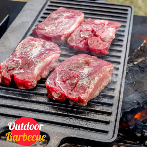 Reversible Cast Iron Grill Pan For Stovetop, 17 By 9.8 Inch Dual Sided Griddle showing steaks cooking on ribbed side over flames