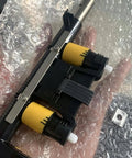 Bulletproof Toggle Bar And Lift Strap Set For ZT410 And ZT411 Thermal Label Printers, black mechanism with yellow rollers.