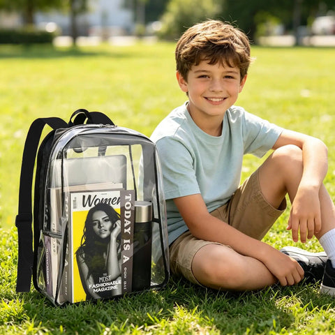 Boy sitting on grass with a See Through Clear Backpack 16 Inch Large Capacity Bookbag for School College Work and Travel, Black