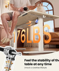 Man sitting on Electric Height Adjustable Standing Desk 48 By 24 Inches With Smooth Lift From 28.3 To 46.5 Inches, holding a cup.
