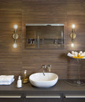 Two Light Matte Brass Vanity Light With Open Sockets Reversible Mount in bathroom setting above mirror