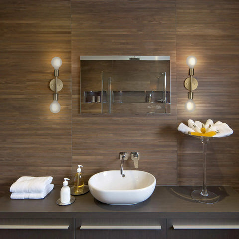 Two Light Matte Brass Vanity Light With Open Sockets Reversible Mount in bathroom setting above mirror