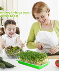 Woman and child with Five Pack Seed Sprouter Tray Kit With Drain Holes For Germination Propagation BPA Free Soil Free Wheatgrass Bean Sprouts Microgreens Growing Kit With 20 Pieces Planting Paper 8.8 By 5.7 Inches Each No Mess Indoor Grow Kit on kitchen counter