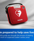 Front view of red Philips HeartStart OnSite AED in slim carry case with carrying strap