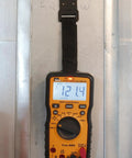 Auto Range Digital Multimeter 600V CAT III NCVT Temp with Backlit Display hanging on metal wall using strap clip