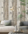 Living room with light grey wood peel and stick wallpaper, 17.7 inch by 393.7 inch, showing distressed wood plank texture.