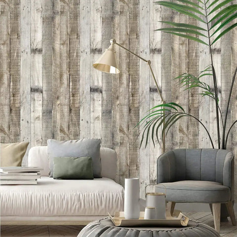 Living room with light grey wood peel and stick wallpaper, 17.7 inch by 393.7 inch, showing distressed wood plank texture.