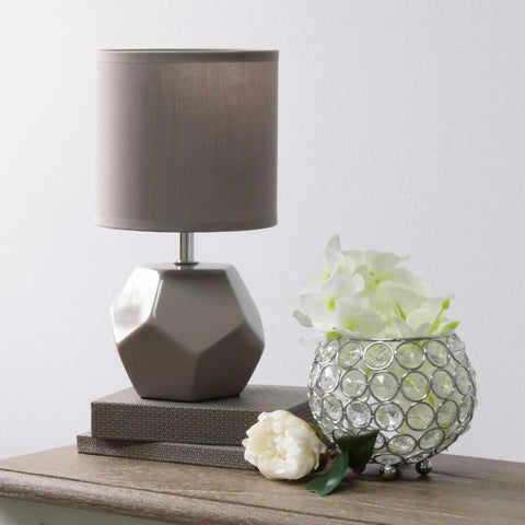 Round Prism Mini Table Lamp With Matching Fabric Shade Black Ceramic Base Compact Desk Light With Easy Rotary Cord Switch Uses 40W Equivalent Candelabra Bulb Or Type G Globe Bulb Not Included next to crystal vase and flowers on wooden table