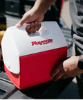 Person holding Playmate Portable Cooler with Tent Top Design, Push Button One Hand Lid Operation, Red Ice Chest for Beach.