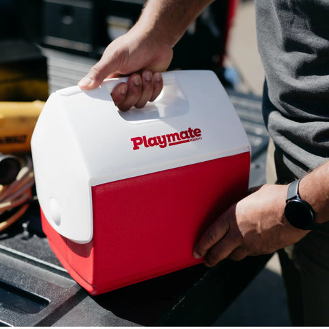 Person holding Playmate Portable Cooler with Tent Top Design, Push Button One Hand Lid Operation, Red Ice Chest for Beach.
