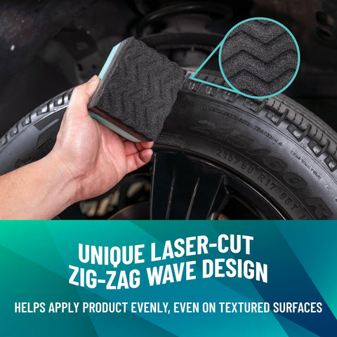 Hand using Wonder Wave Durafoam Tire Shine Applicator Pad on truck tire sidewall with zig-zag wave design visible.