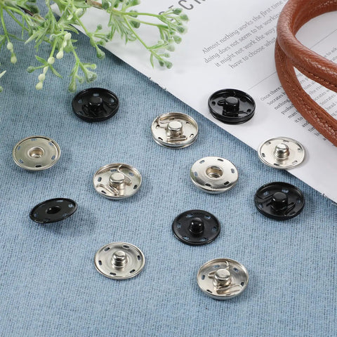24 Sets Large Snaps For Sewing 25mm Aluminum Snap Buttons in silver and black on blue fabric background
