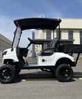 Two Seater Electric Golf Cart With 48V Lithium Battery And Heavy Duty Plastic Bed Powered By A Badass 4Kw Motor in white, side view.