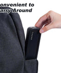 Hand placing Grab And Go 4 Piece Stainless Steel Travel Utensils Set With Reinforced Buckle Case in backpack pocket, black case.