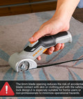 User operating DEKOPRO 4v Cordless Electric Scissors With Safety Lock on carpet material for precise cutting.