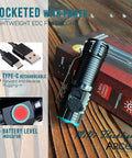 Rechargeable Compact EDC Flashlight With Clip on wooden table, USB cable, and battery level indicator displayed.