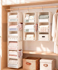 Snap Together Six Tier Hanging Closet Organizer, Collapsible Wardrobe Rack For Dorms, Beige with fabric shelves holding folded items.