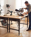 Man using Beefy 48 Inch Adjustable Heavy Duty Workbench With 2000 Lbs Load Capacity, Wood Work Table With Power Strip, Pegboard And Six Hooks
