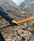 Person using 10 Pound Sledge Hammer for Heavy Duty Demolition with 35 Inch Fiberglass Handle on rocky terrain
