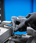 Hands using the Master Grade 150 Piece Socket Set With Quarter Inch And Half Inch Drives featuring a super lock socket on an engine.