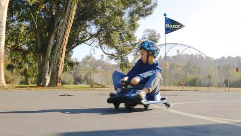 Child riding Crazy Cart Shift Electric Go Kart for Kids Ages 6 and Up 12V Drifting System with High and Low Speed Switch outdoors