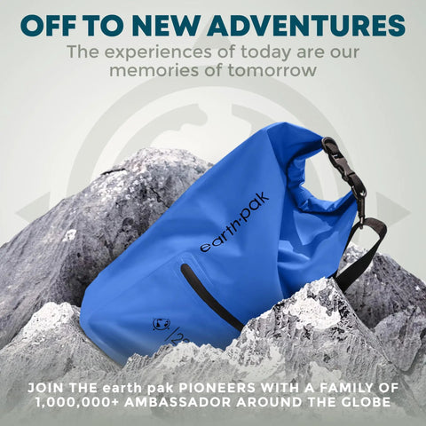 Blue waterproof dry bag backpack with zippered pocket on rocky mountain background.