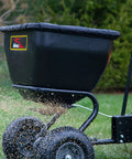 Deluxe Tow Behind Broadcast Spreader With Extended Easy Reach Handle And Weatherproof Cover, 175 lb capacity spreading seed