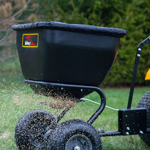 Deluxe Tow Behind Broadcast Spreader With Extended Easy Reach Handle And Weatherproof Cover, 175 lb capacity spreading seed